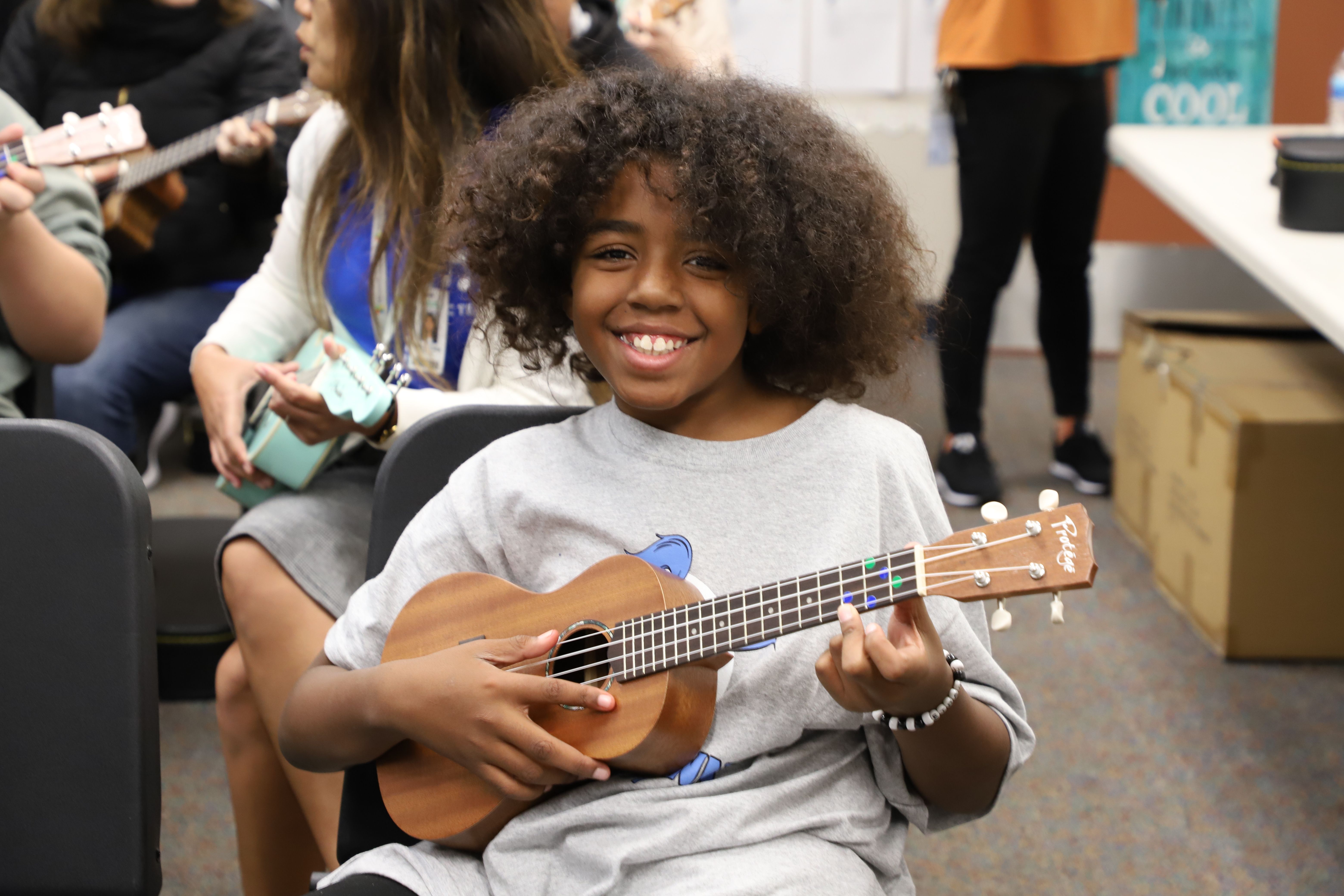 middle school child learning the uke during NAMM's Day of Service at The 2020 NAMM Show