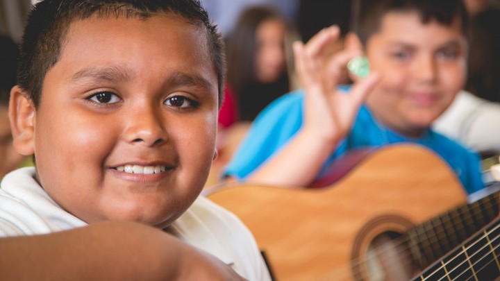 photo of kids playing the guitar