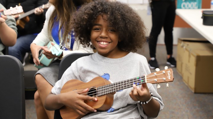 NAMM's Day of Service middle school child learning the uke during NAMM's Day of Service at The 2020 NAMM Show