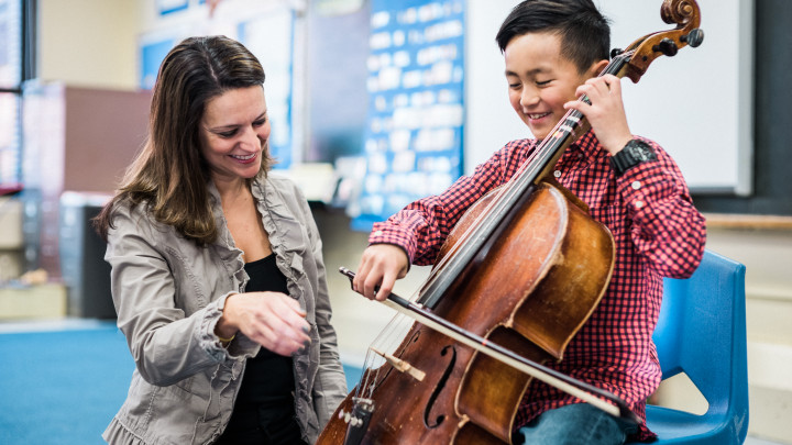 Boy playing an instrument in elementary school