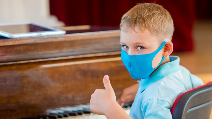 Masked piano student