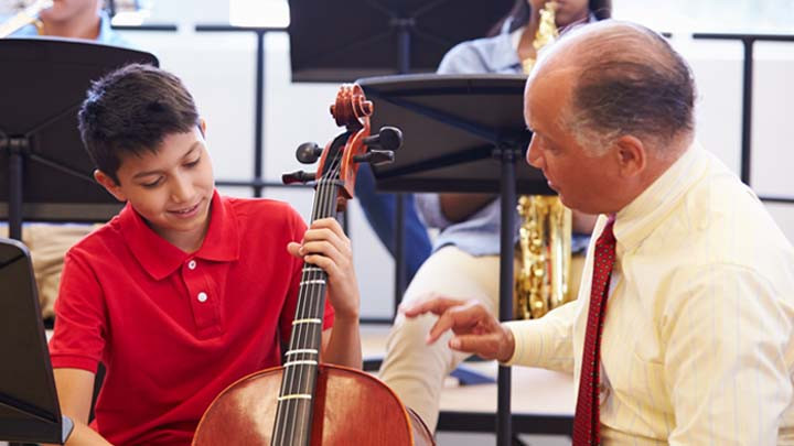 Music teacher and student learning an instrument