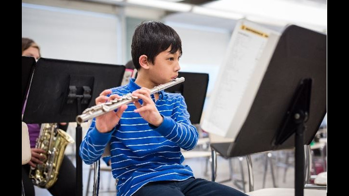 Elementary School Student Playing the Flute