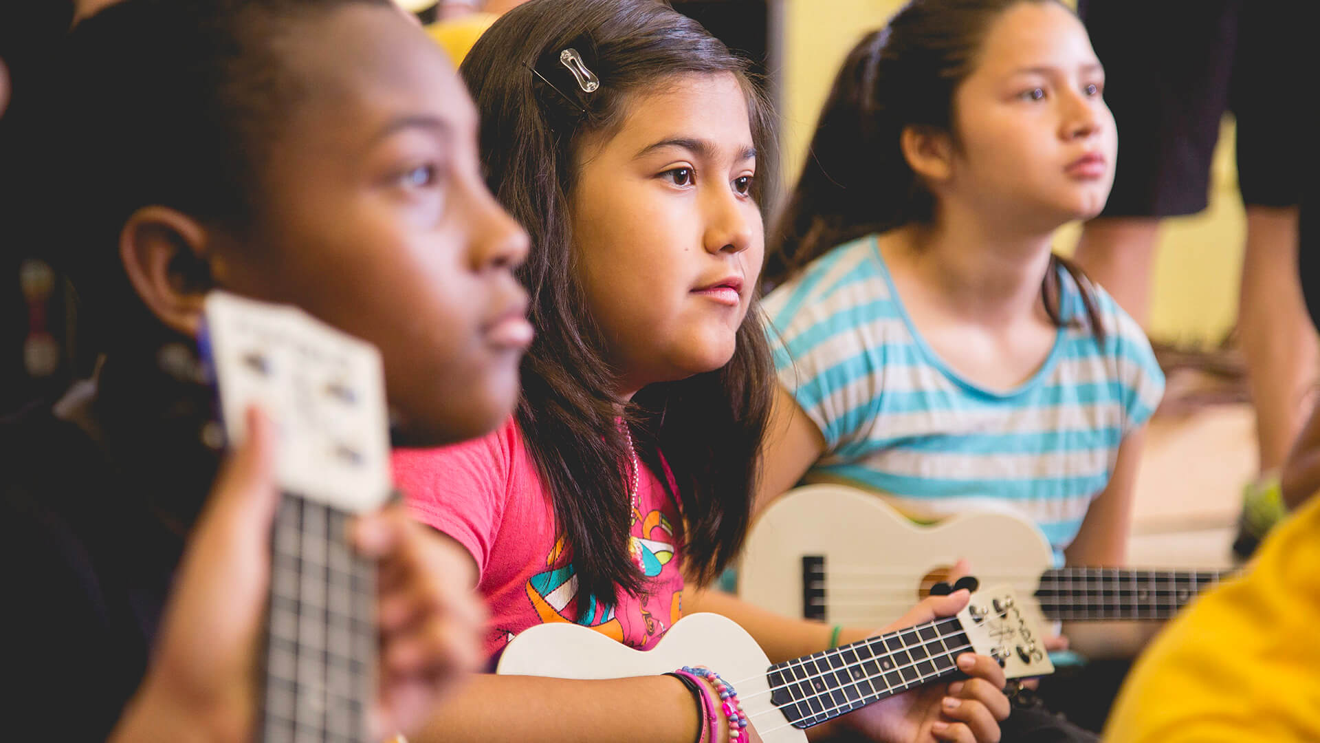 Girls playing ukulele